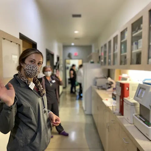 Woman waving at the camera in the hall at The Ark Veterinary Clinic Woman waving at the camera in the hall at The Ark Veterinary Clinic