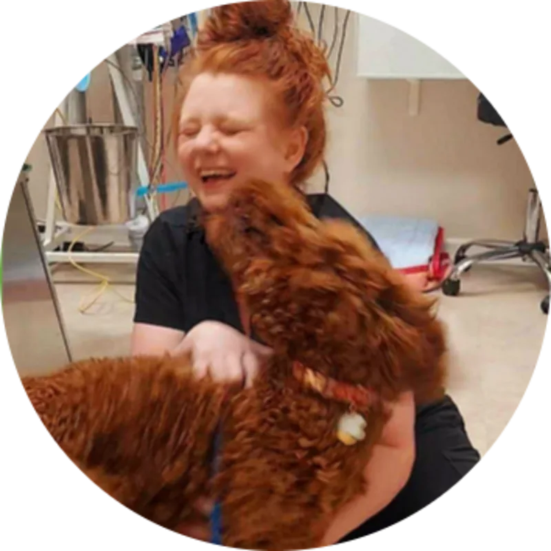 Picture of Dr. Angela Cox embracing a brown dog at Lake Chatuge. Picture of Dr. Angela Cox embracing a brown dog at Lake Chatuge.