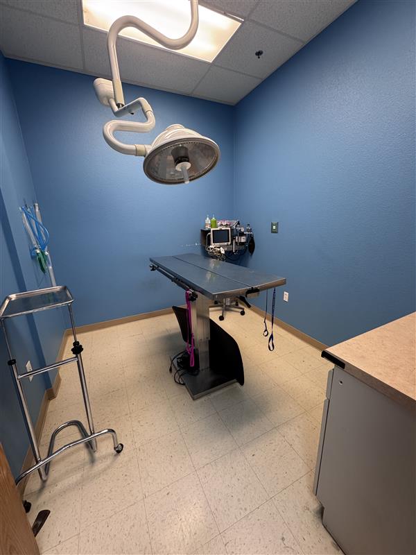 Angled view of the surgery operating room with metal operating table