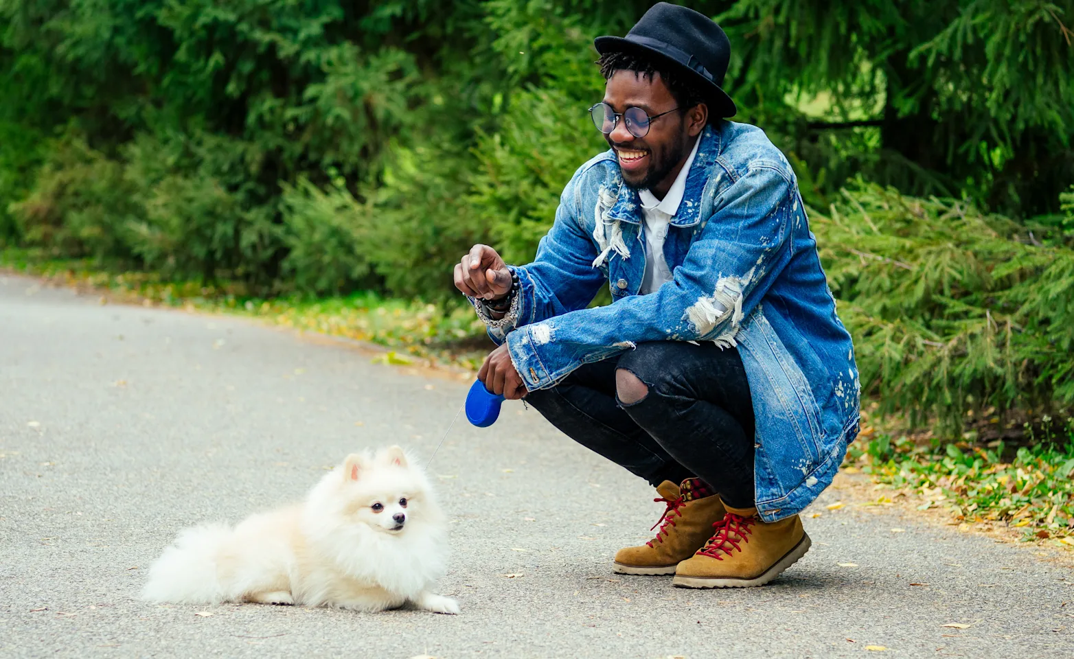 Dog with man sitting in street on a walk Dog with man sitting in street on a walk