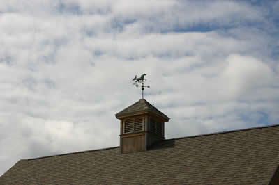 Horse sign on top of barn