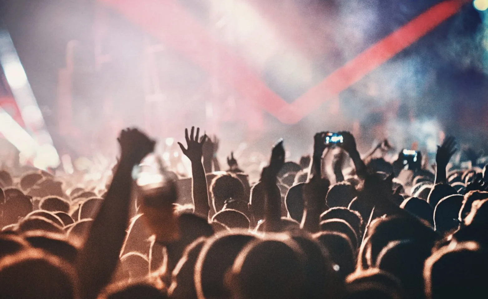 A crowd of people watching a concert. A crowd of people watching a concert.