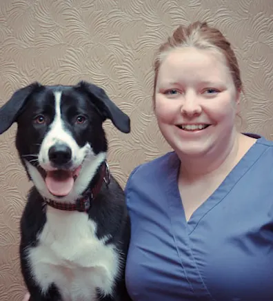Kate Dean holding onto a black and white dog Kate Dean holding onto a black and white dog