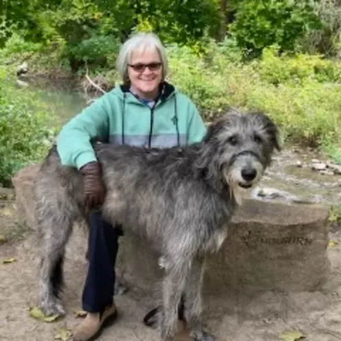 Sandra McBride in a nature setting with her Irish Wolfhound Sandra McBride in a nature setting with her Irish Wolfhound