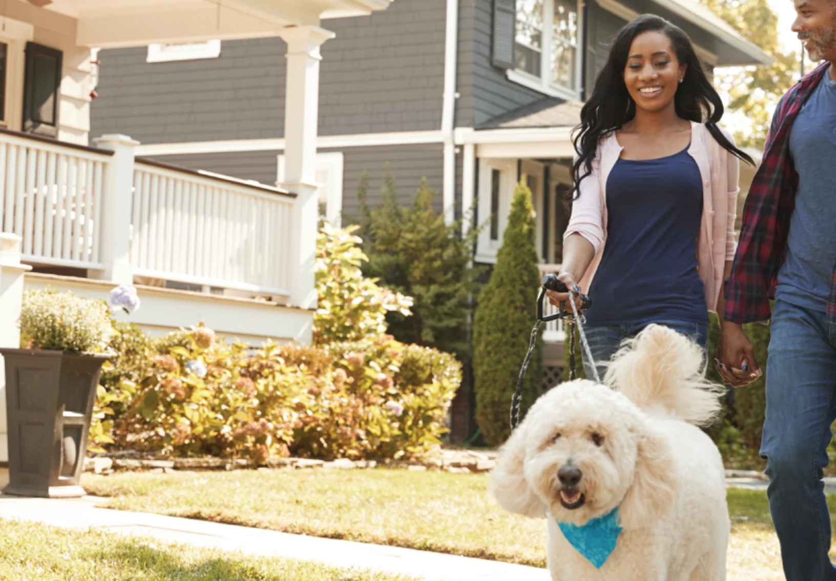 Family walking dog out in front of house Family walking dog out in front of house
