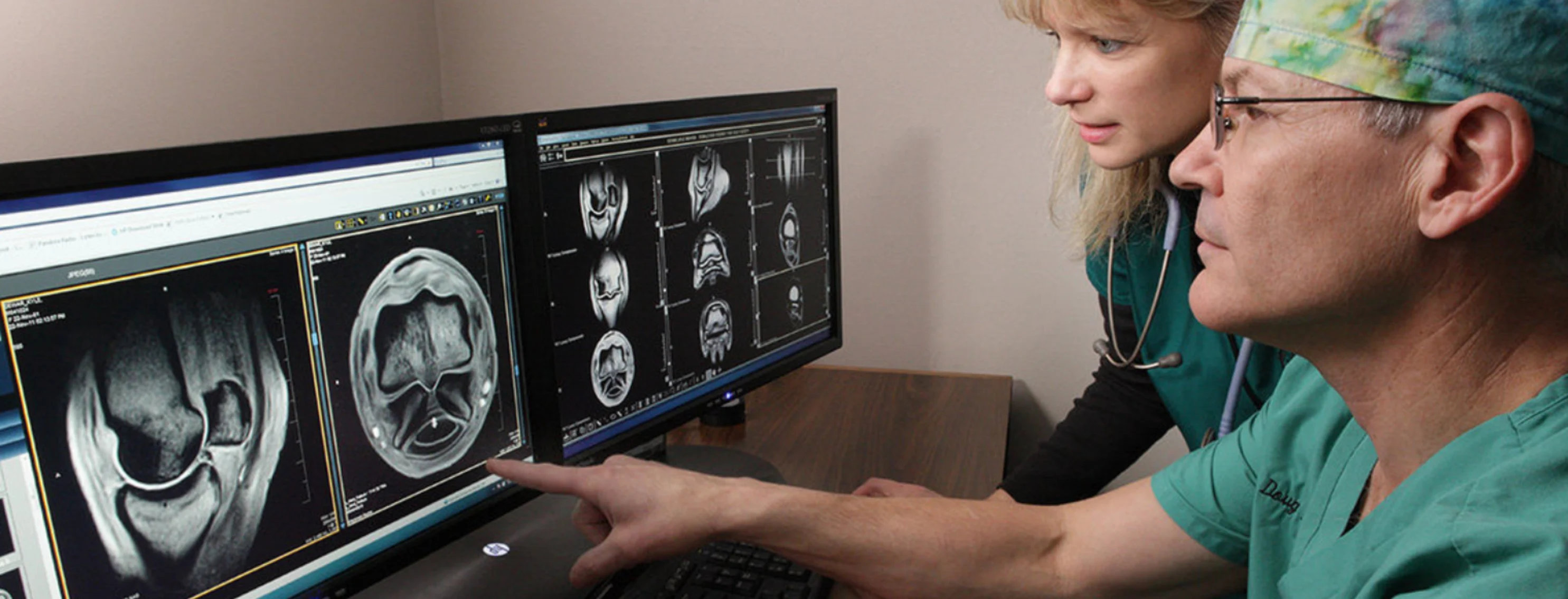 Two WECH veterinarians looking at an x-ray of a hoof on computer screens