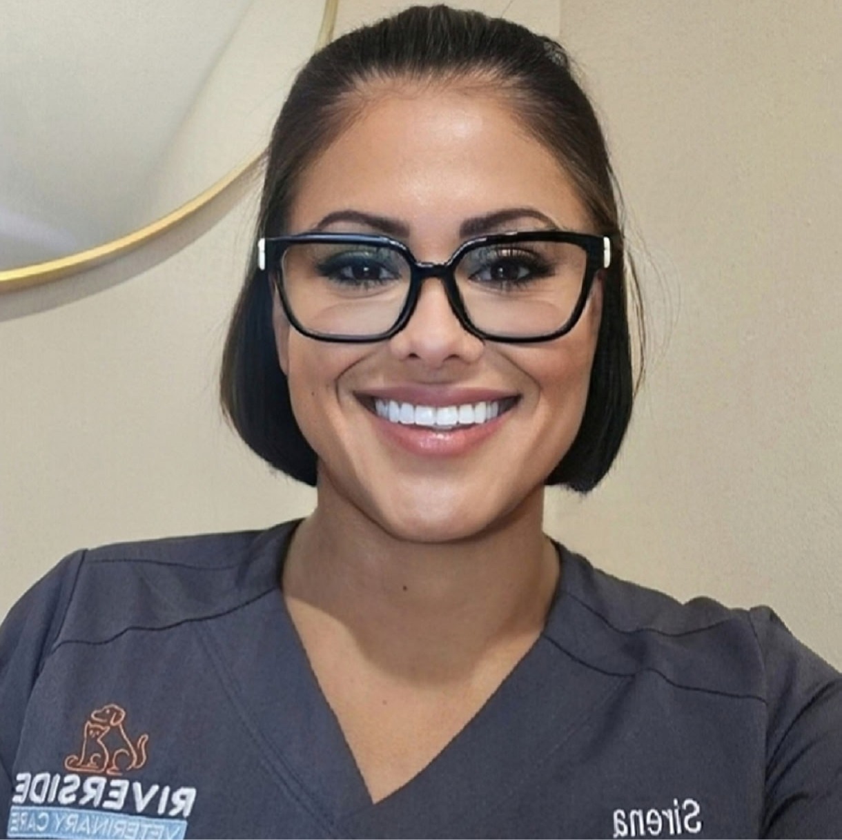 Sirena's staff photo from Riverside Animal Hospital South cuddling cat