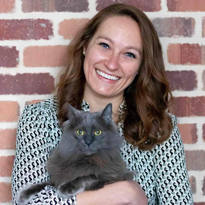 Dr. Mei, Vet at Rose Valley Veterinary Hospital, holding a grey cat Dr. Mei, Vet at Rose Valley Veterinary Hospital, holding a grey cat