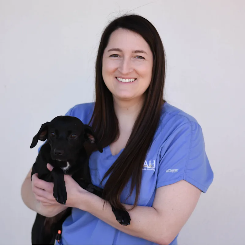 Megan Mayer holding a small brown dog Megan Mayer holding a small brown dog