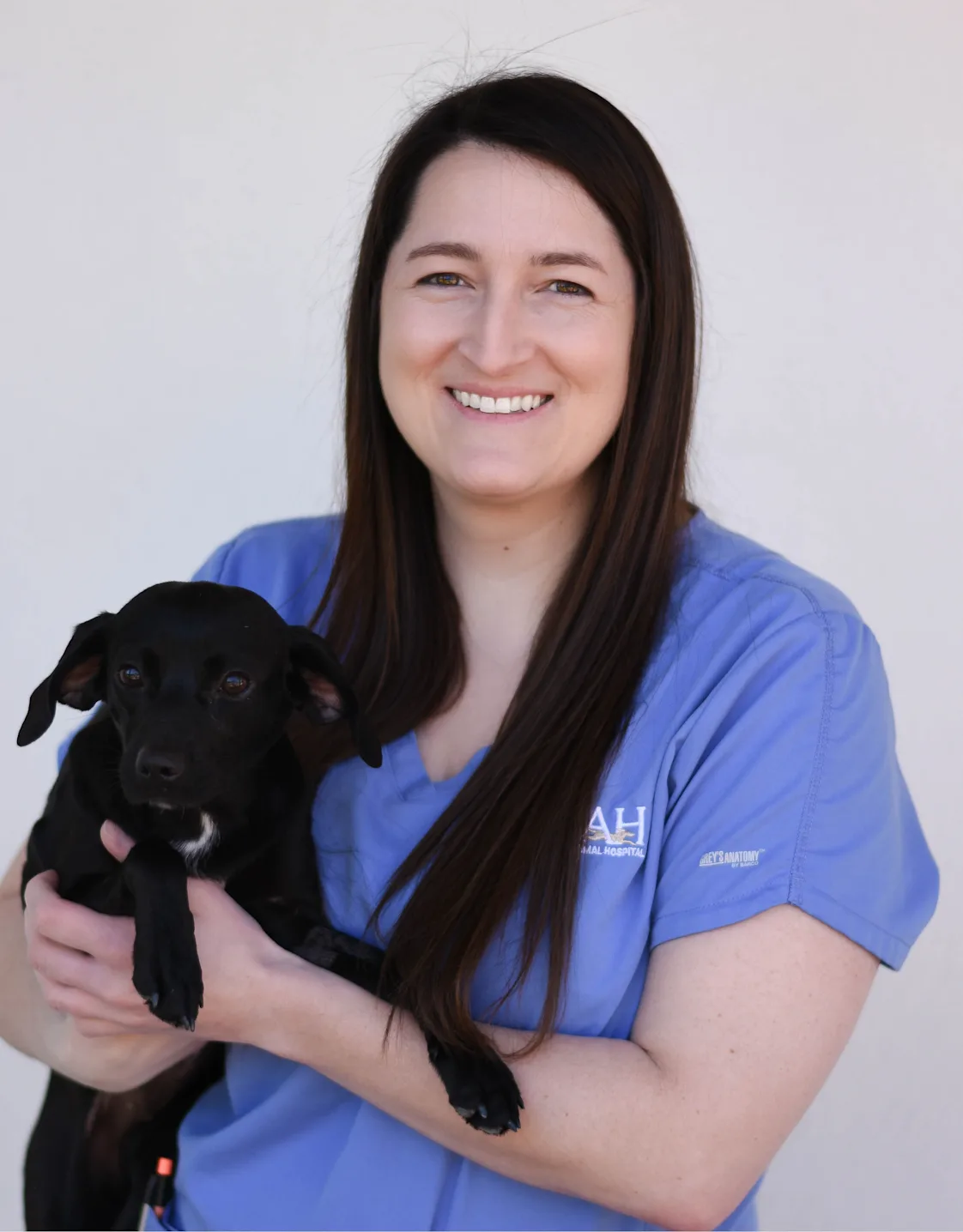 Megan Mayer holding a small brown dog Megan Mayer holding a small brown dog