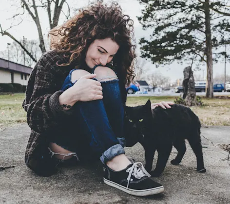 woman petting cat woman petting cat