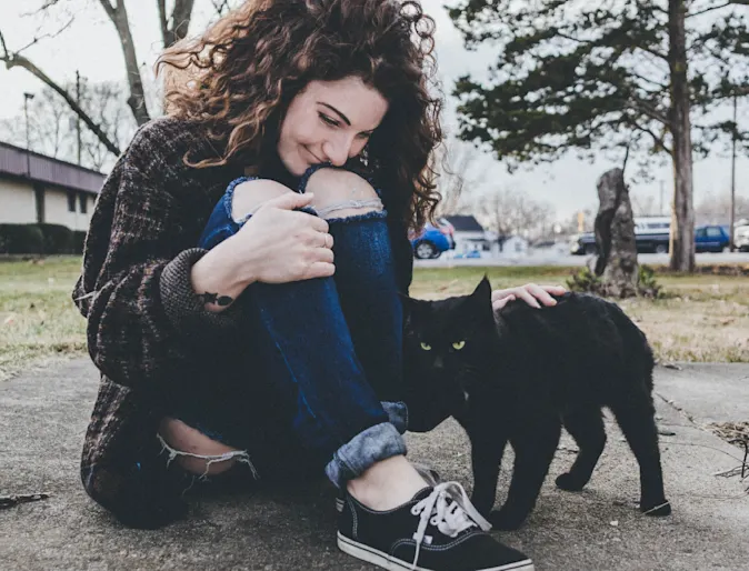 woman petting cat