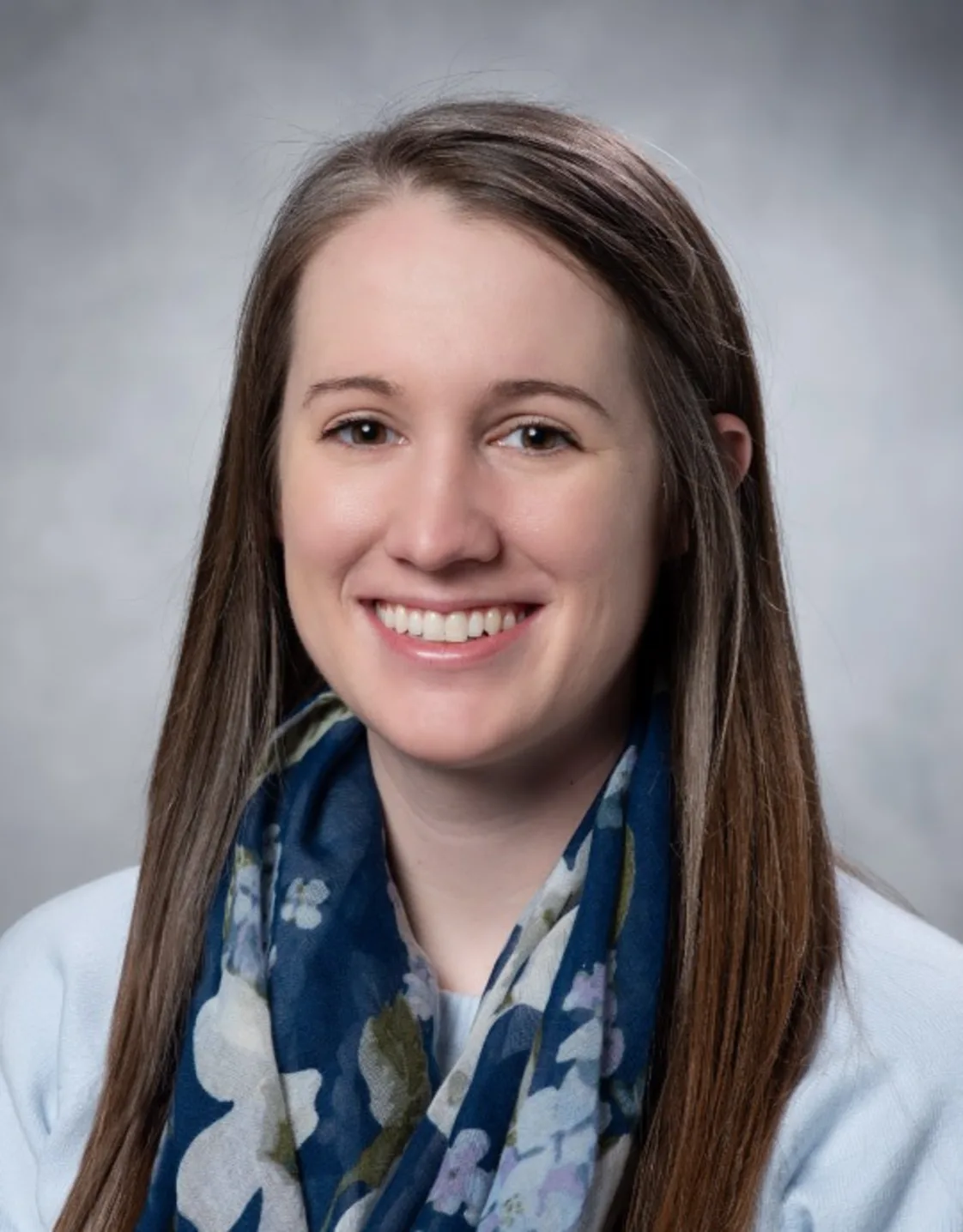 Young white woman with long brown hair smiling and holding two small dogs. Young white woman with long brown hair smiling and holding two small dogs.