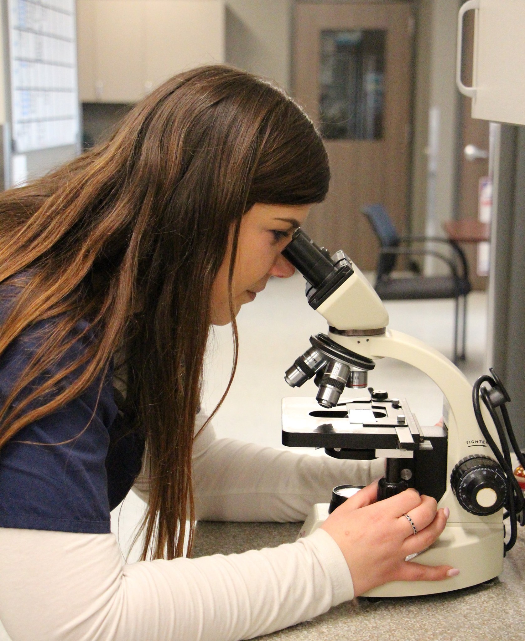 Doctor looking into microscope