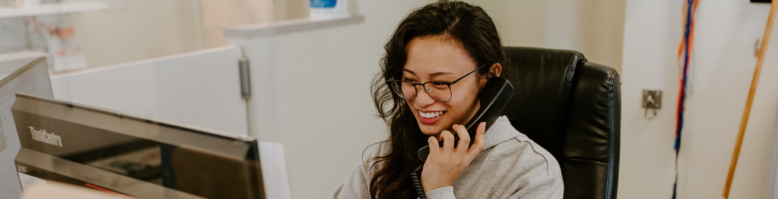 Staff Front Desk on phone at Shoreline Central
