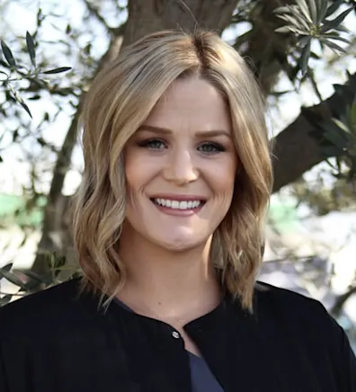 Woman with black cardigan smiling at camera Woman with black cardigan smiling at camera