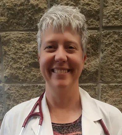 Dr. Peterson smiling with a golden retriever. Dr. Peterson smiling with a golden retriever.