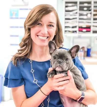 Marian Rowland smiling holding a grey French Bull Dog Marian Rowland smiling holding a grey French Bull Dog