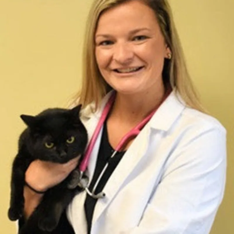Dr. Abigail holding a black cat. Dr. Abigail holding a black cat.