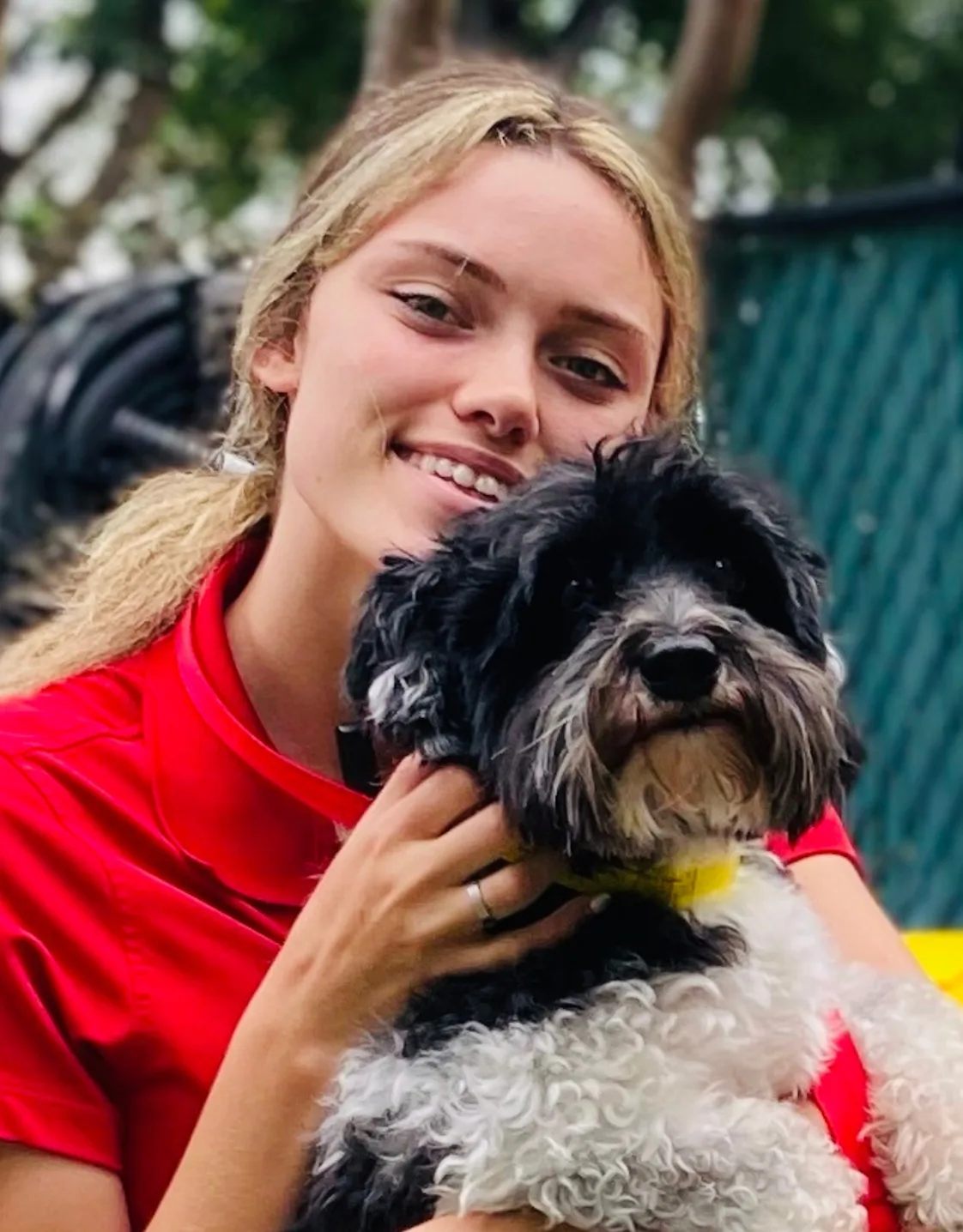 Ambria B. in red shirt with a black dog Ambria B. in red shirt with a black dog