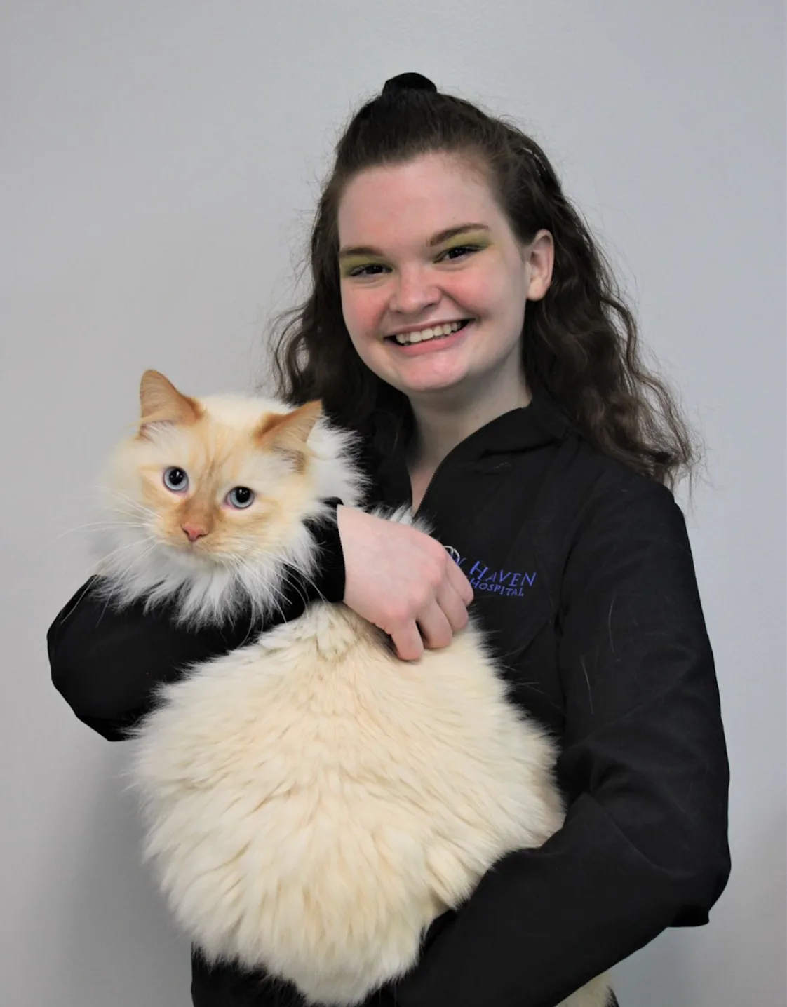 Autumn holding a fluffy cat with blue eyes Autumn holding a fluffy cat with blue eyes