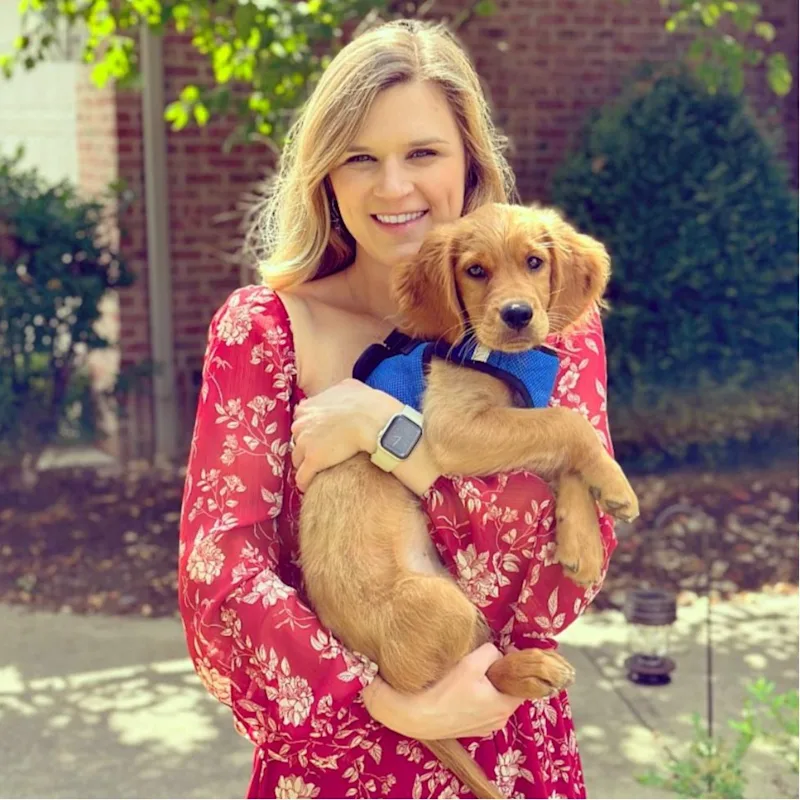 Dr. Folkerts, Veterinarian at Animal Hospital of Towne Lake, holding a small dog Dr. Folkerts, Veterinarian at Animal Hospital of Towne Lake, holding a small dog