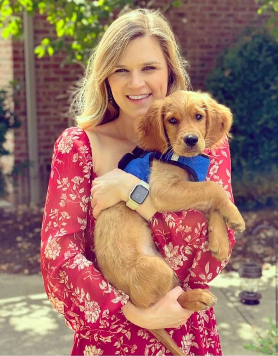 Dr. Folkerts, Veterinarian at Animal Hospital of Towne Lake, holding a small dog Dr. Folkerts, Veterinarian at Animal Hospital of Towne Lake, holding a small dog