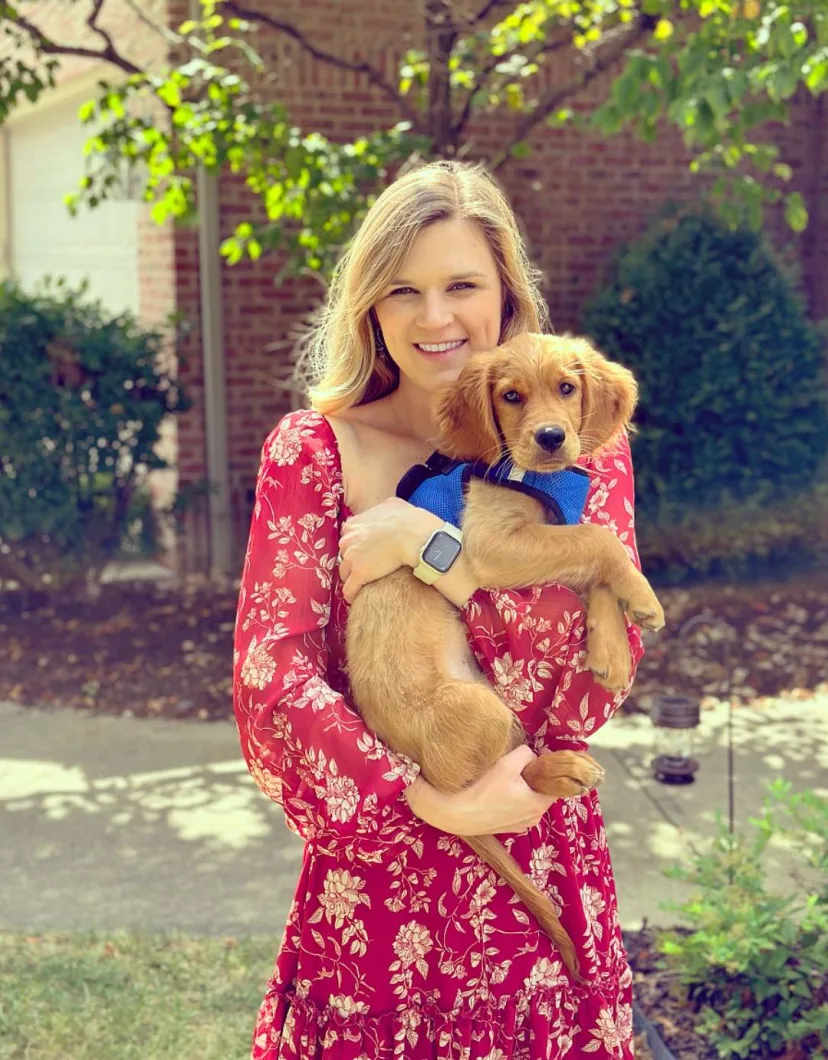 Dr. Folkerts, Veterinarian at Animal Hospital of Towne Lake, holding a small dog