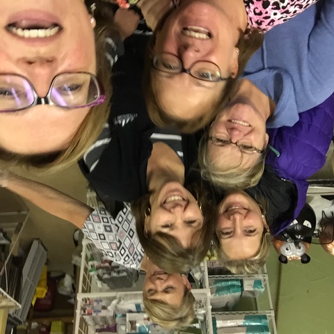 Sandra McBride smiling in selfie taken at work with 5 co-workers