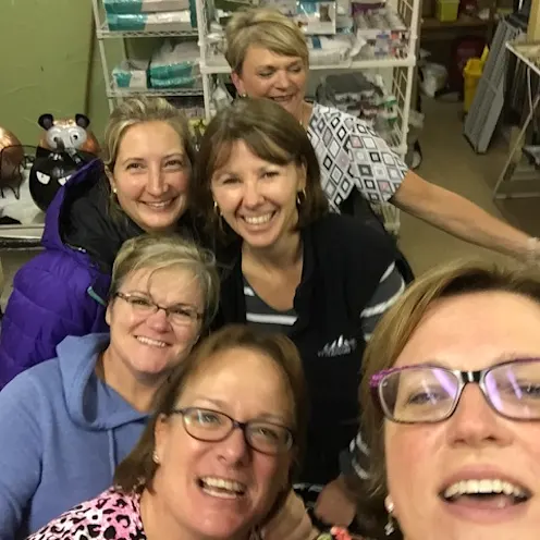 Sandra McBride smiling in selfie taken at work with 5 co-workers Sandra McBride smiling in selfie taken at work with 5 co-workers