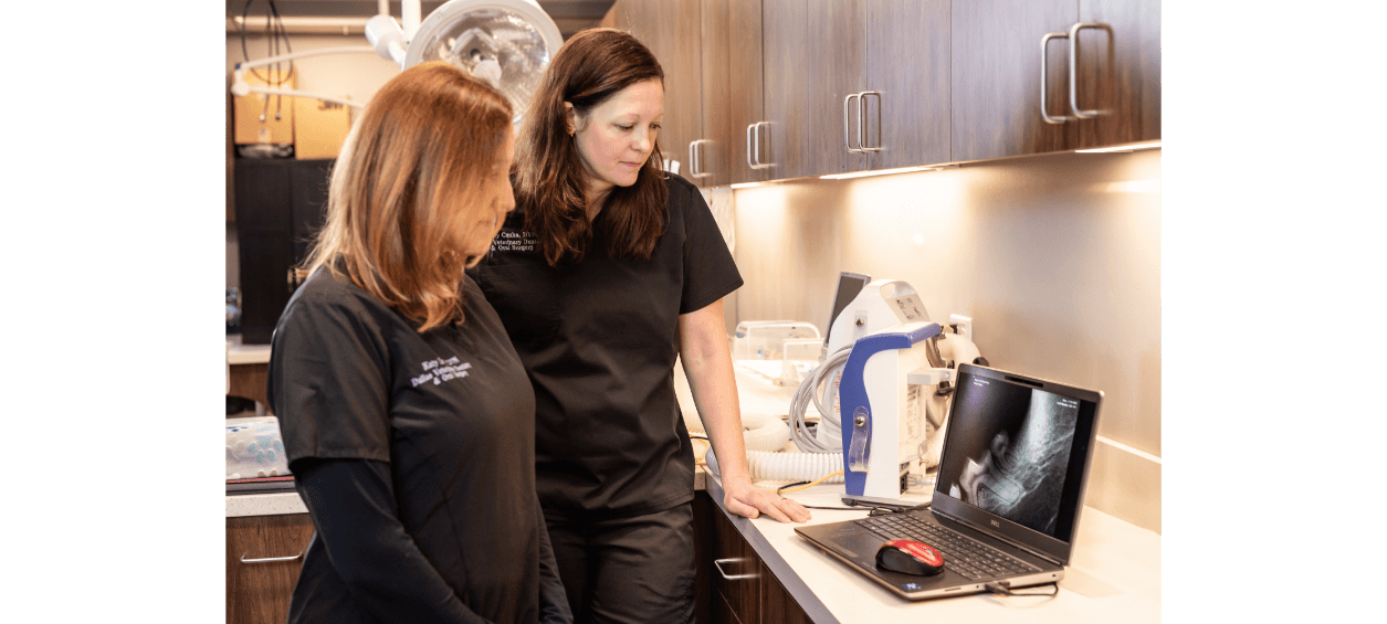 Two staff members looking an an x-ray