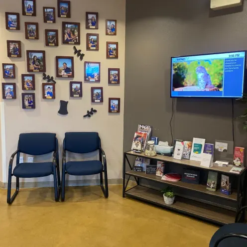 Waiting area with many photo frames on the white wall.