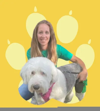 Tiffany hugging a dog with a yellow backdrop.