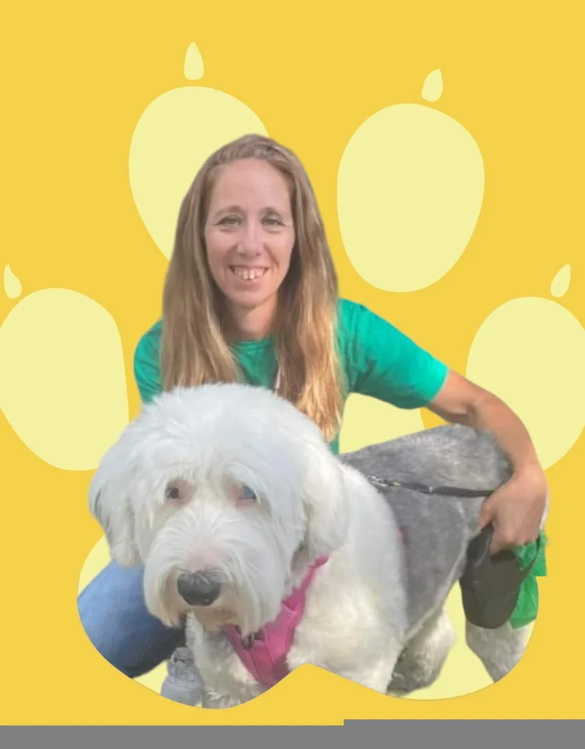 Tiffany hugging a dog with a yellow backdrop.