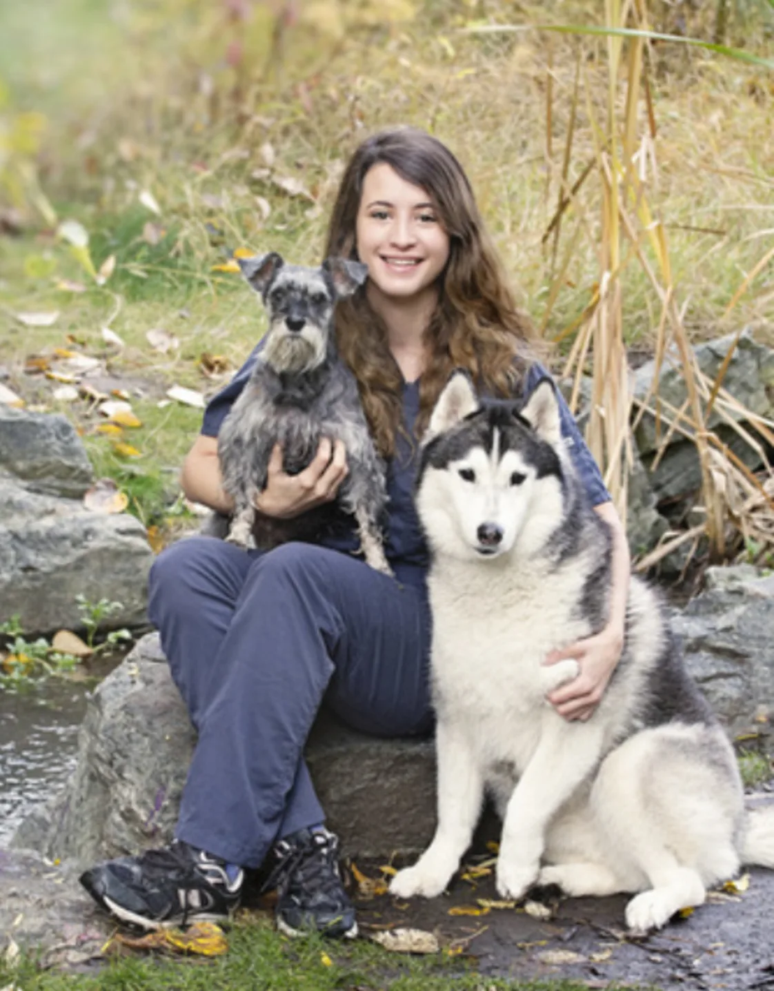 Kristen sitting with one little dog and one big dog Kristen sitting with one little dog and one big dog
