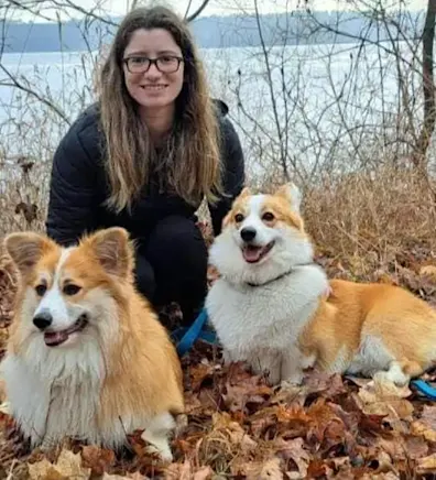 Staff photo of Shannon with two corgis Staff photo of Shannon with two corgis