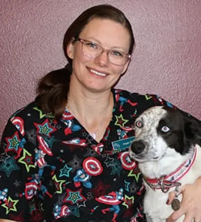 Megan smiling while holding a dog Megan smiling while holding a dog