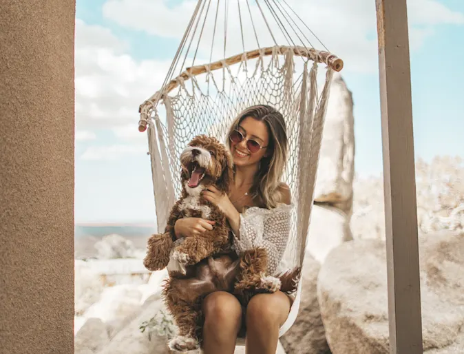 Dog and woman swinging on a swing. Dog and woman swinging on a swing.