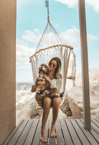 Dog and woman swinging on a swing. Dog and woman swinging on a swing.