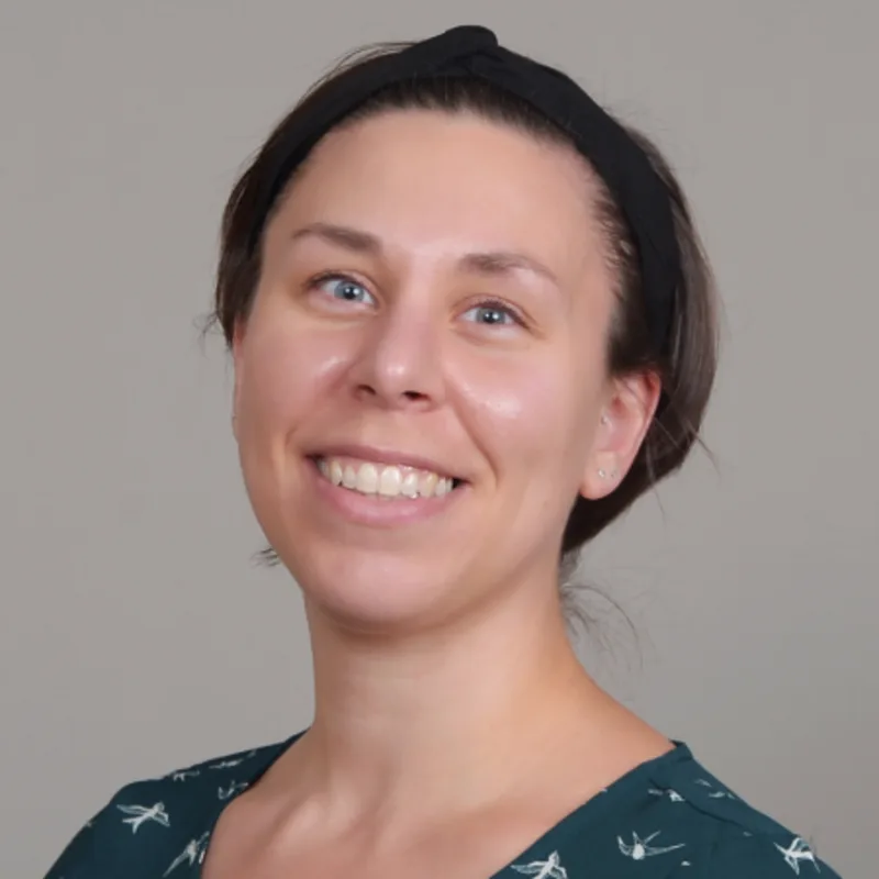 Marissa Ann Portillo smiling in front of a grey wall Marissa Ann Portillo smiling in front of a grey wall