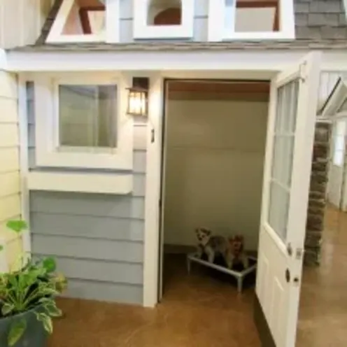 A dog laying on a small bed inside a house-like suite at Clarksville Kennels A dog laying on a small bed inside a house-like suite at Clarksville Kennels