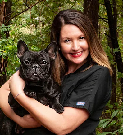 Crystal Thielepape Holding a Black Dog