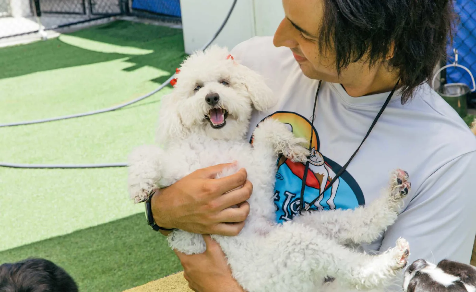 Pet Lodge staff holding a puppy