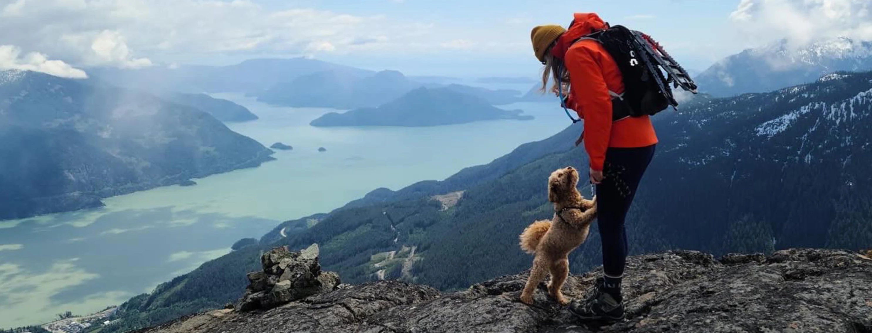 Dr. Paige and her dog hiking at the top of a mountain in Squamish, BC. Dr. Paige and her dog hiking at the top of a mountain in Squamish, BC.