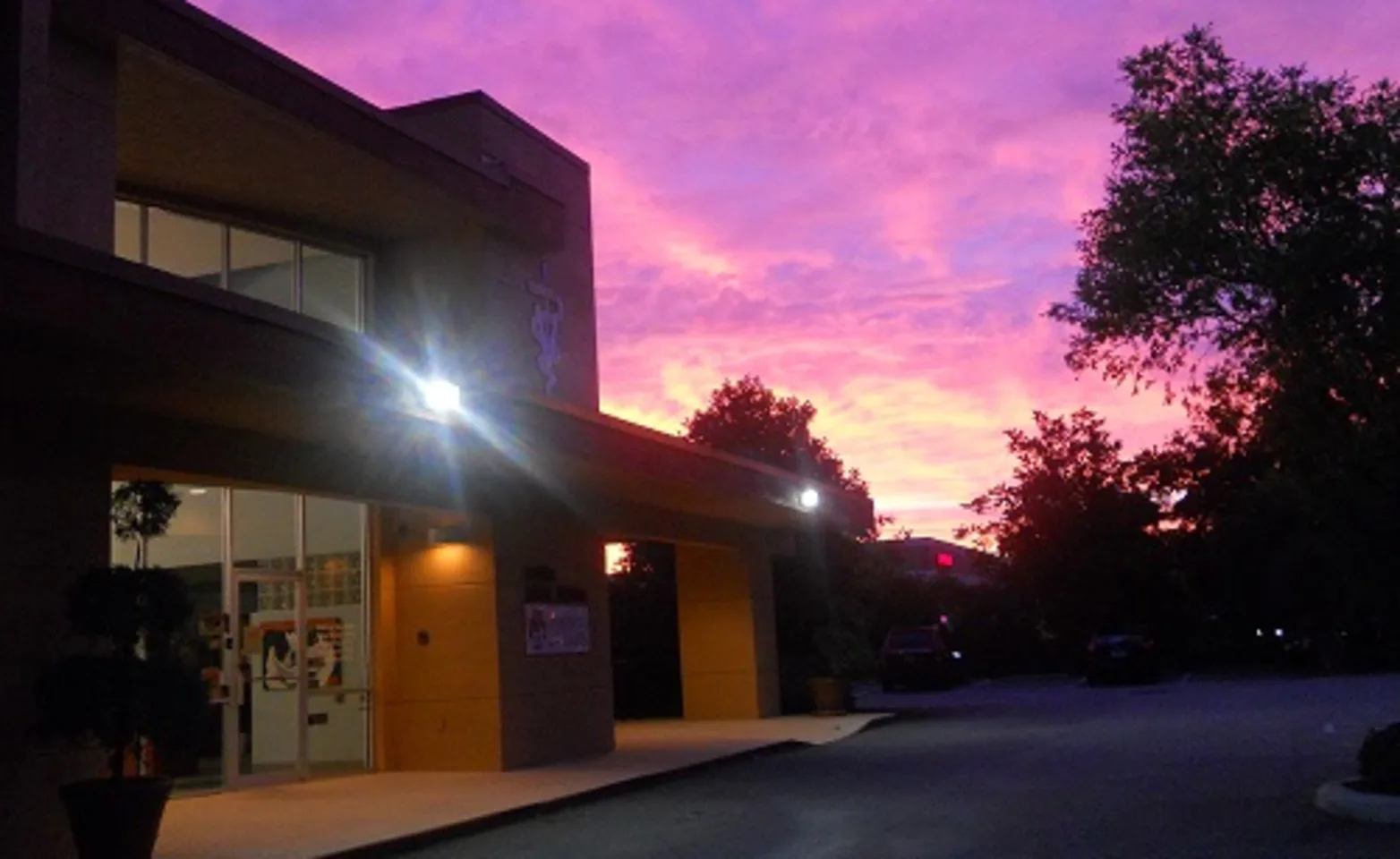 Exterior view of the building at night with a pink sky. Exterior view of the building at night with a pink sky.