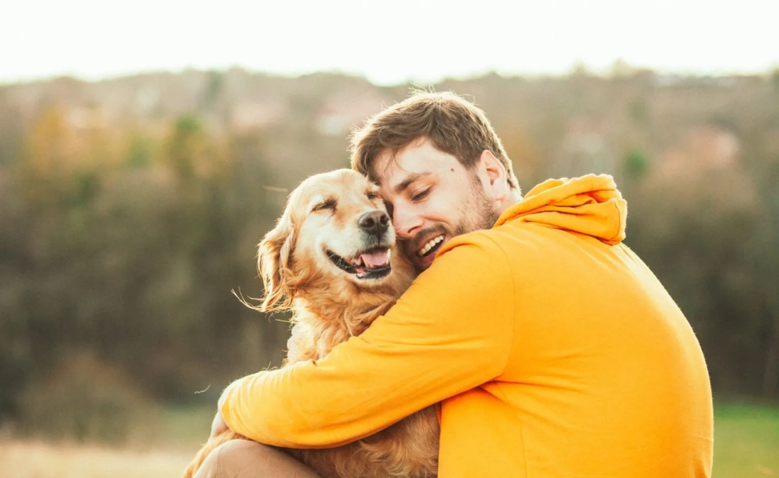 Man hugging golden retriever Man hugging golden retriever