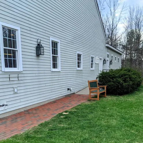 Outside of Henniker Veterinary Hospital where there is a nice sitting bench and a lawn for dogs to run around Outside of Henniker Veterinary Hospital where there is a nice sitting bench and a lawn for dogs to run around