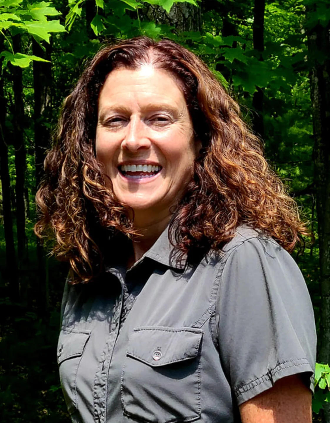 Dr. Pam Buchli smiling standing outside in front of trees Dr. Pam Buchli smiling standing outside in front of trees