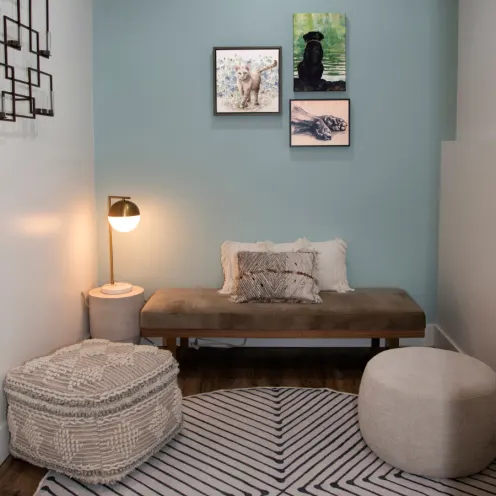 Waiting area with a bench and two stools 