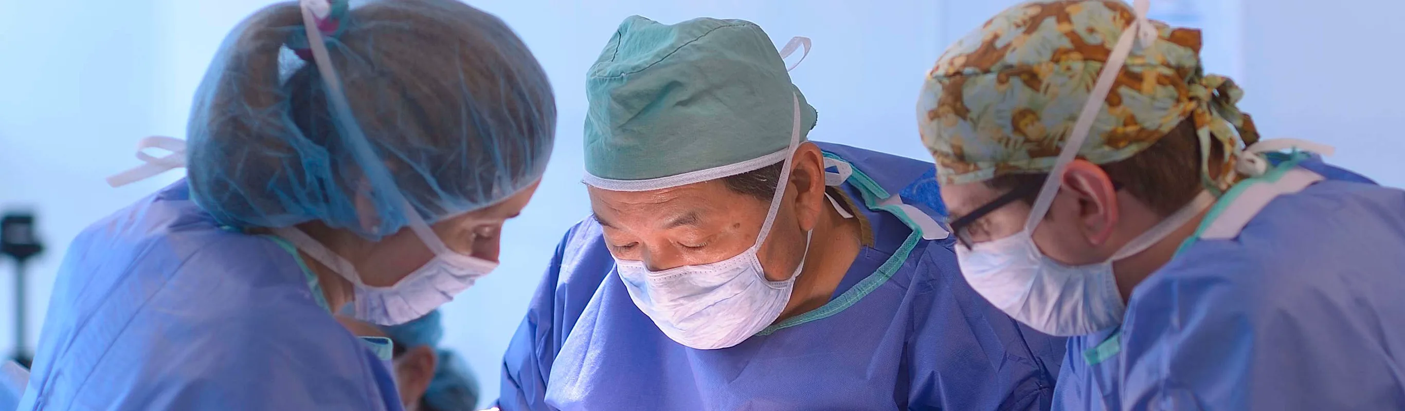 Surgeons performing surgery on a patient. Surgeons performing surgery on a patient.